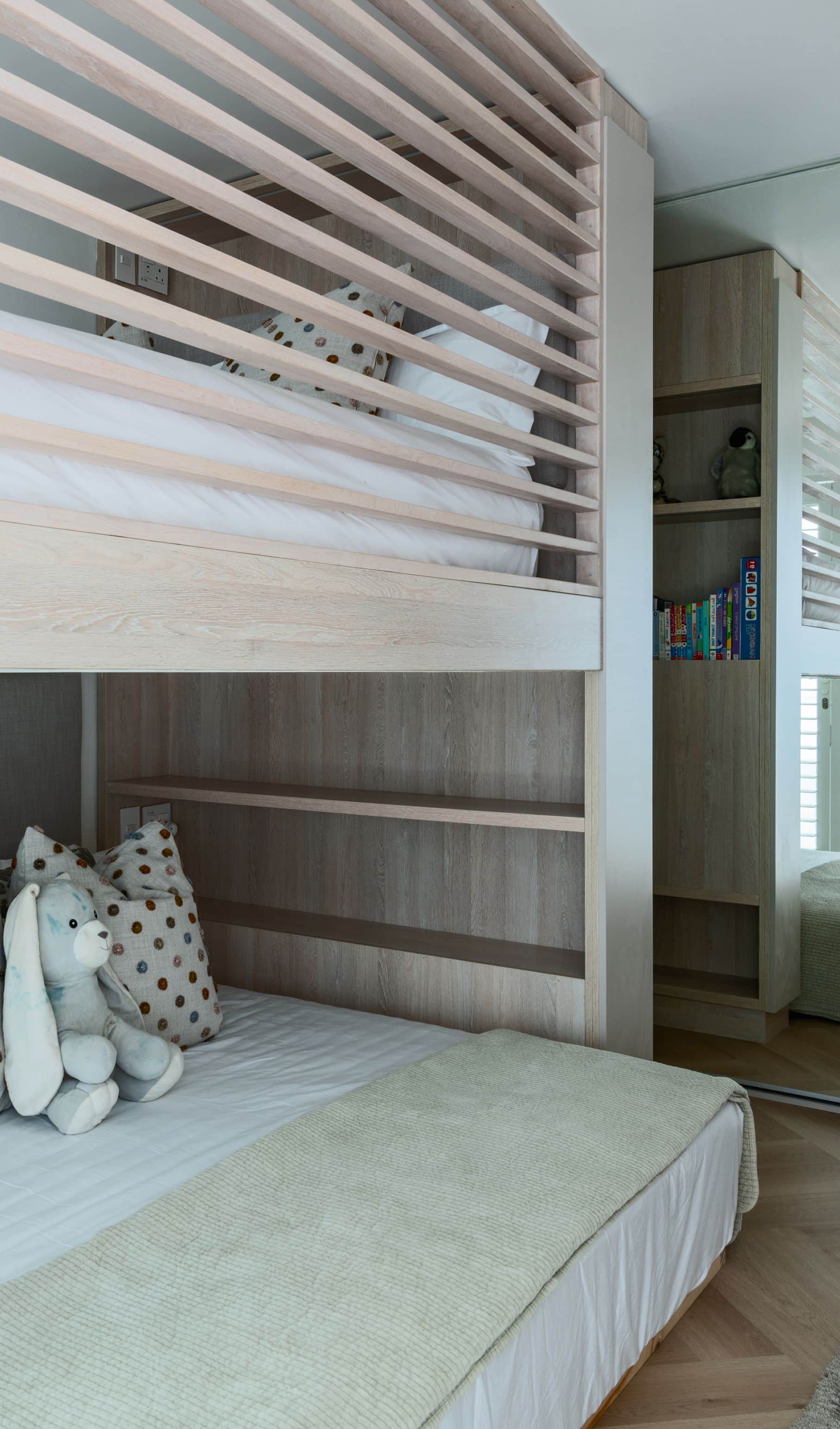 Children’s room with a custom pale oak bunk bed and built-in shelving